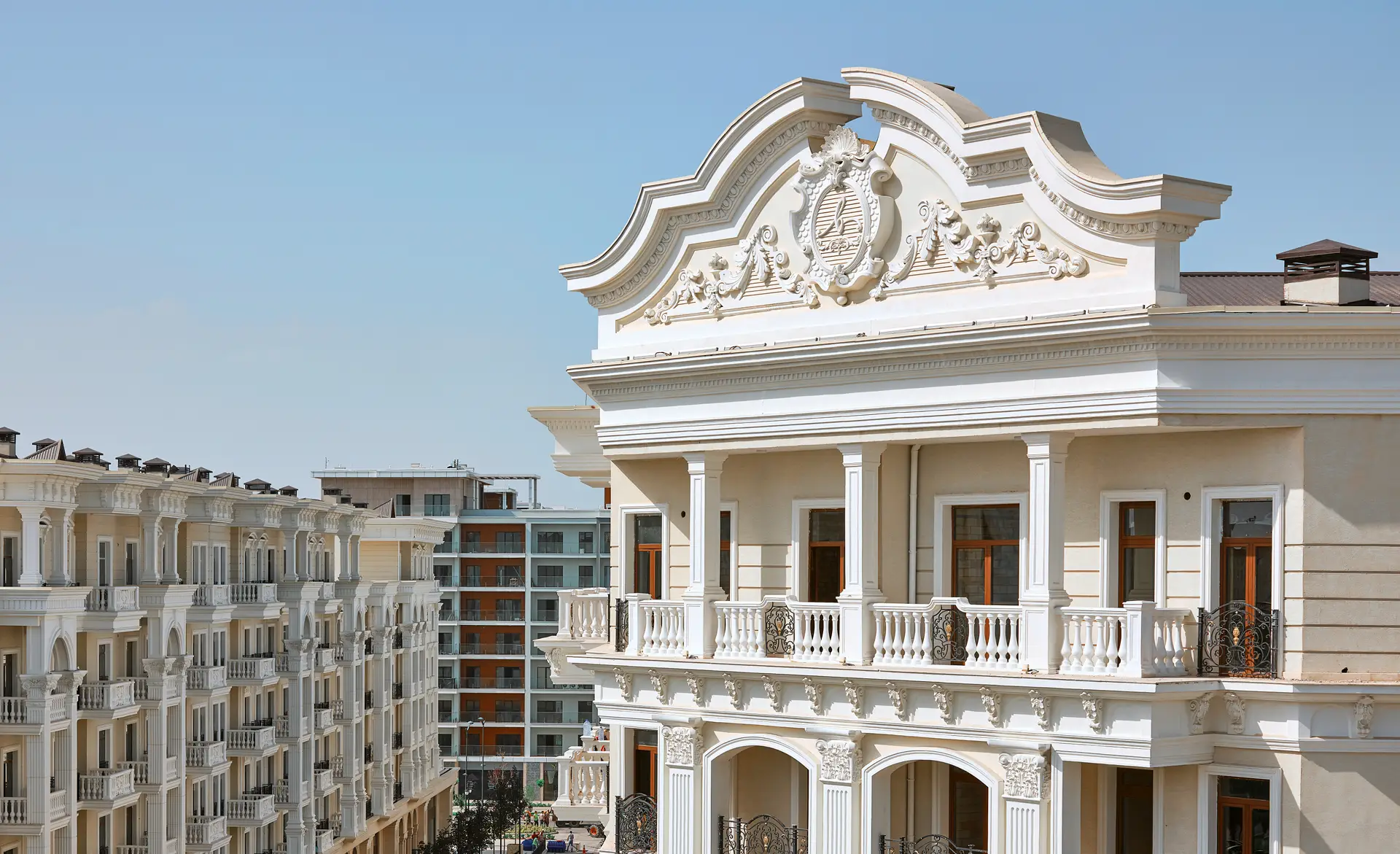 Residential real estate development with neoclassical architecture and balcony details.